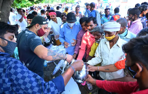 Volunteers serving meals to homeless people